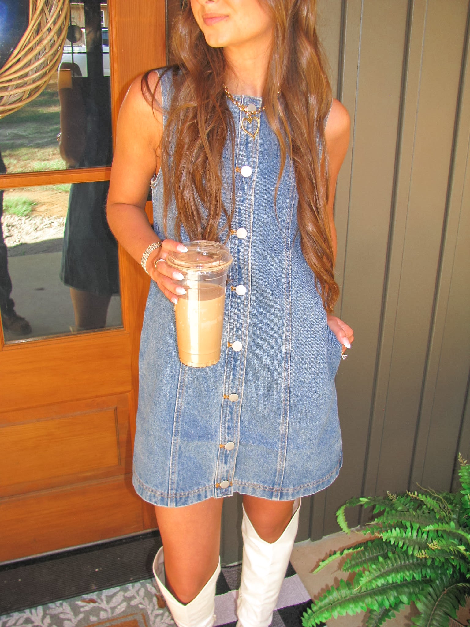 woman showing off vintage button down denim dress